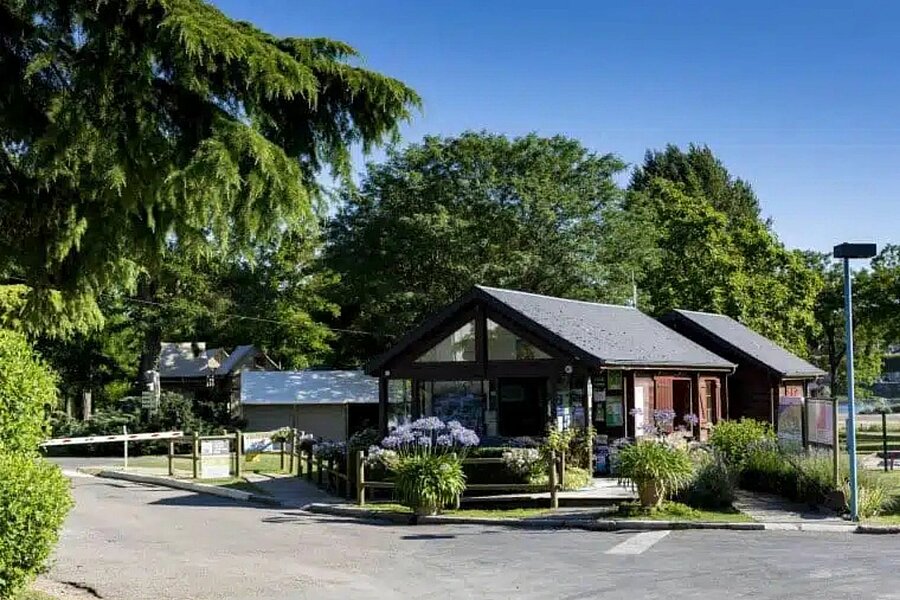 Entrée et réception du camping Touristique de Gien, dans le Loiret, entourée de verdure et offrant un cadre paisible pour des vacances en pleine nature.