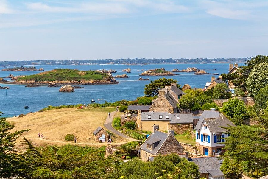 Vue sur l’île de Bréhat près de Paimpol, maisons en pierre et îlots verdoyants baignés par la mer turquoise de Bretagne nord.