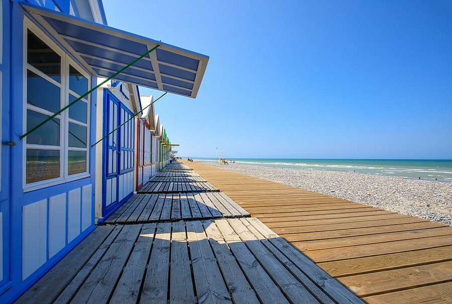 Cabines de plage colorées et promenade en bois à Cayeux-sur-Mer, en bord de mer, paysage emblématique de la Baie de Somme.