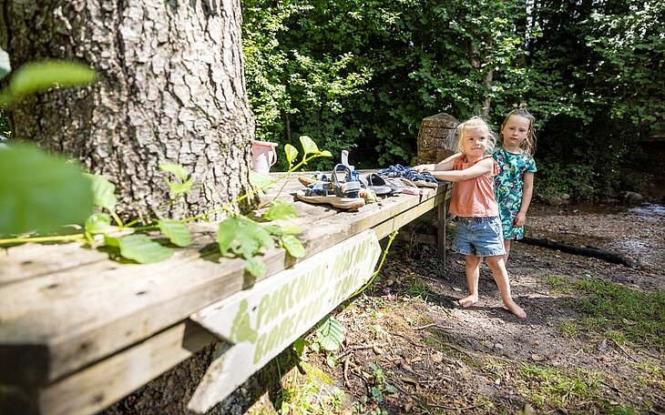 Sentier pieds nus au camping Au Clos de la Chaume à Corcieux Deux enfants découvrent le sentier pieds nus du camping Au Clos de la Chaume à Corcieux, expérience nature conviviale pour le tourisme à Corcieux.