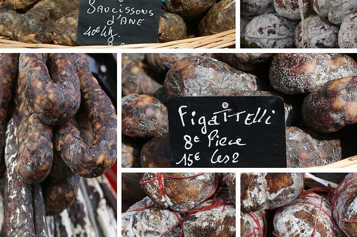 Charcuterie corse à Sainte-Lucie de Porto-Vecchio, avec figatelli et saucissons artisanaux, une expérience gourmande incontournable pour découvrir les saveurs locales.