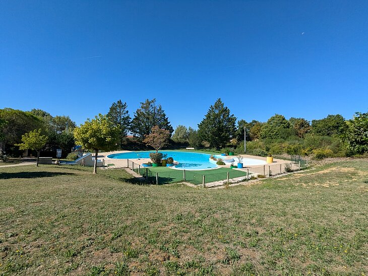 Piscine lagon du camping Le Faillal dans le Tarn-et-Garonne Grande piscine lagon entourée d’arbres au camping Le Faillal à Montpezat-de-Quercy, dans le Tarn-et-Garonne.