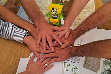 Des mains se rejoignent autour d'une table, symbolisant le partenariat et la transparence de l'adhésion à Sites et Paysages. L'image met en avant l'accompagnement, l'intégration et la formation offerts dès la première année, ainsi qu'un modèle économique clair et sans surprise pour un investissement raisonnable et une montée en puissance assurée. Rejoindre Sites et Paysages, c'est s'engager dans un réseau authentique et convivial depuis 1982.